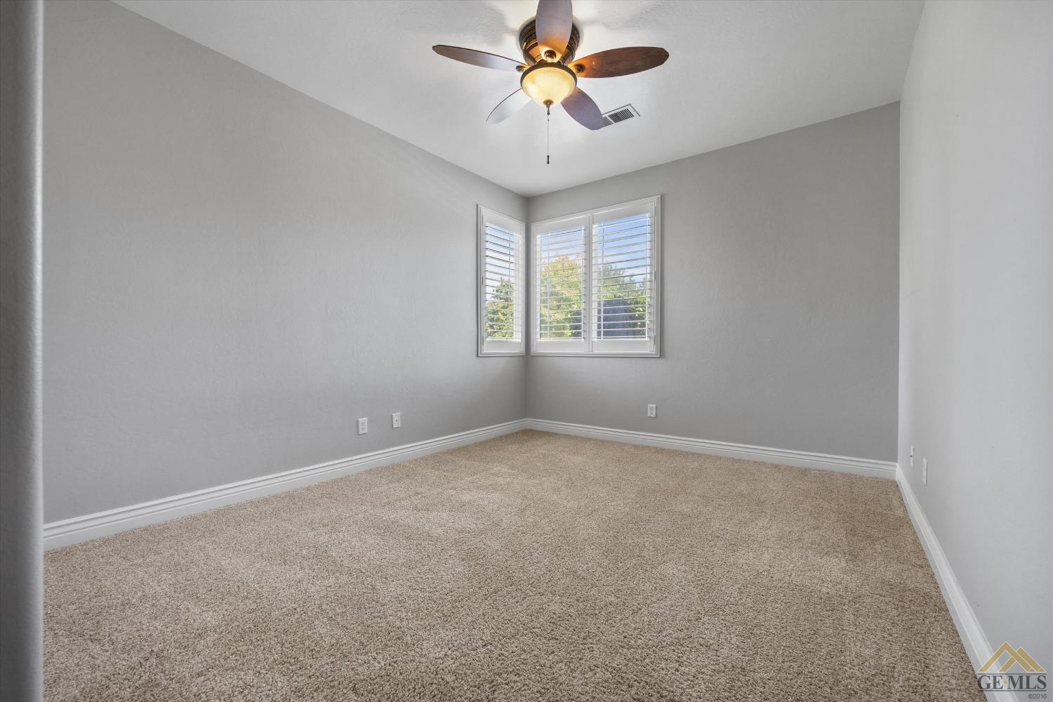 Undisclosed Address Bakersfield, CA 93311 - Photo 40 of 57 an empty room with windows and fan