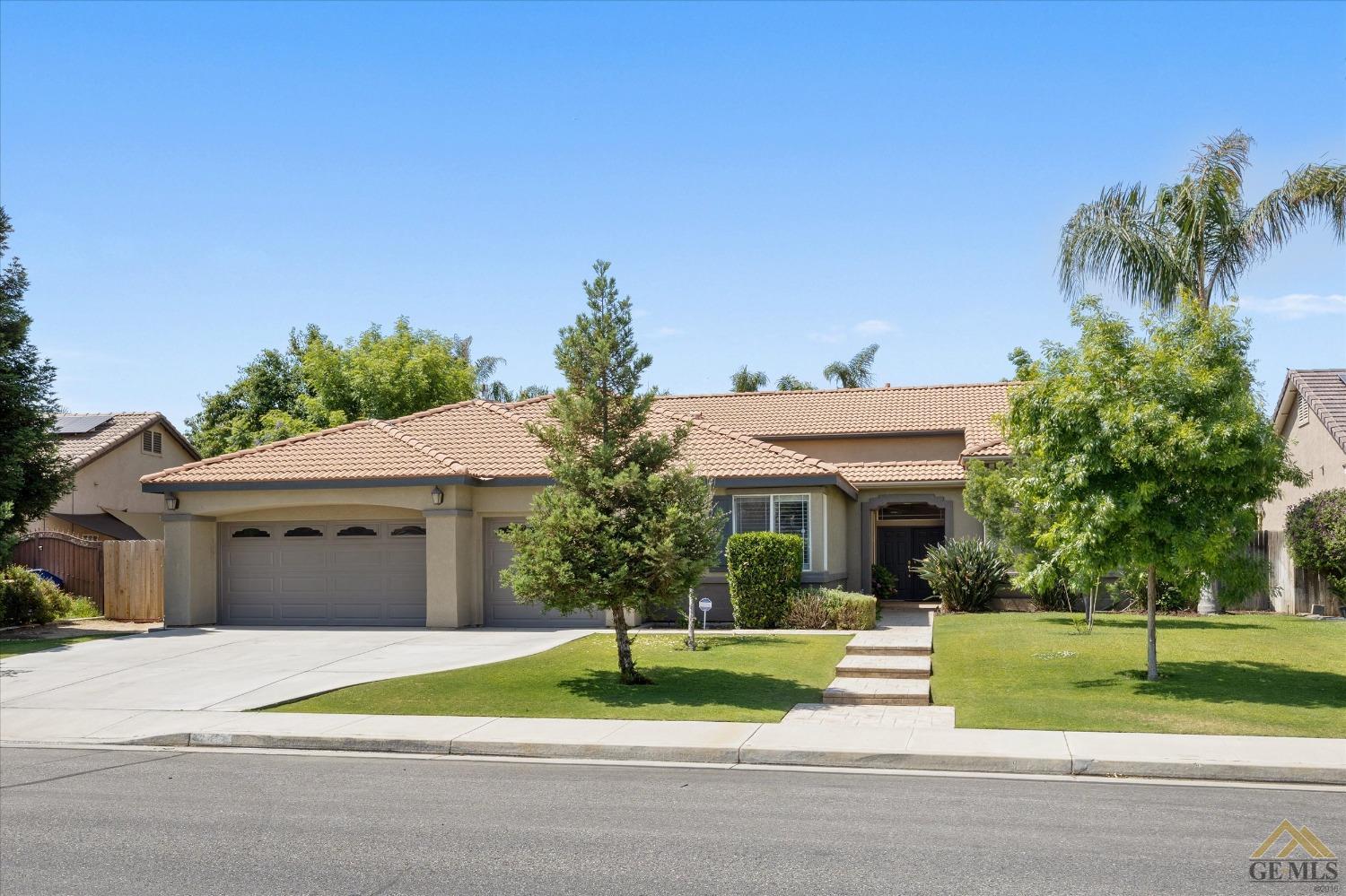 Undisclosed Address Bakersfield, CA 93311 - Photo 4 of 57 a front view of a house with a yard and potted plants