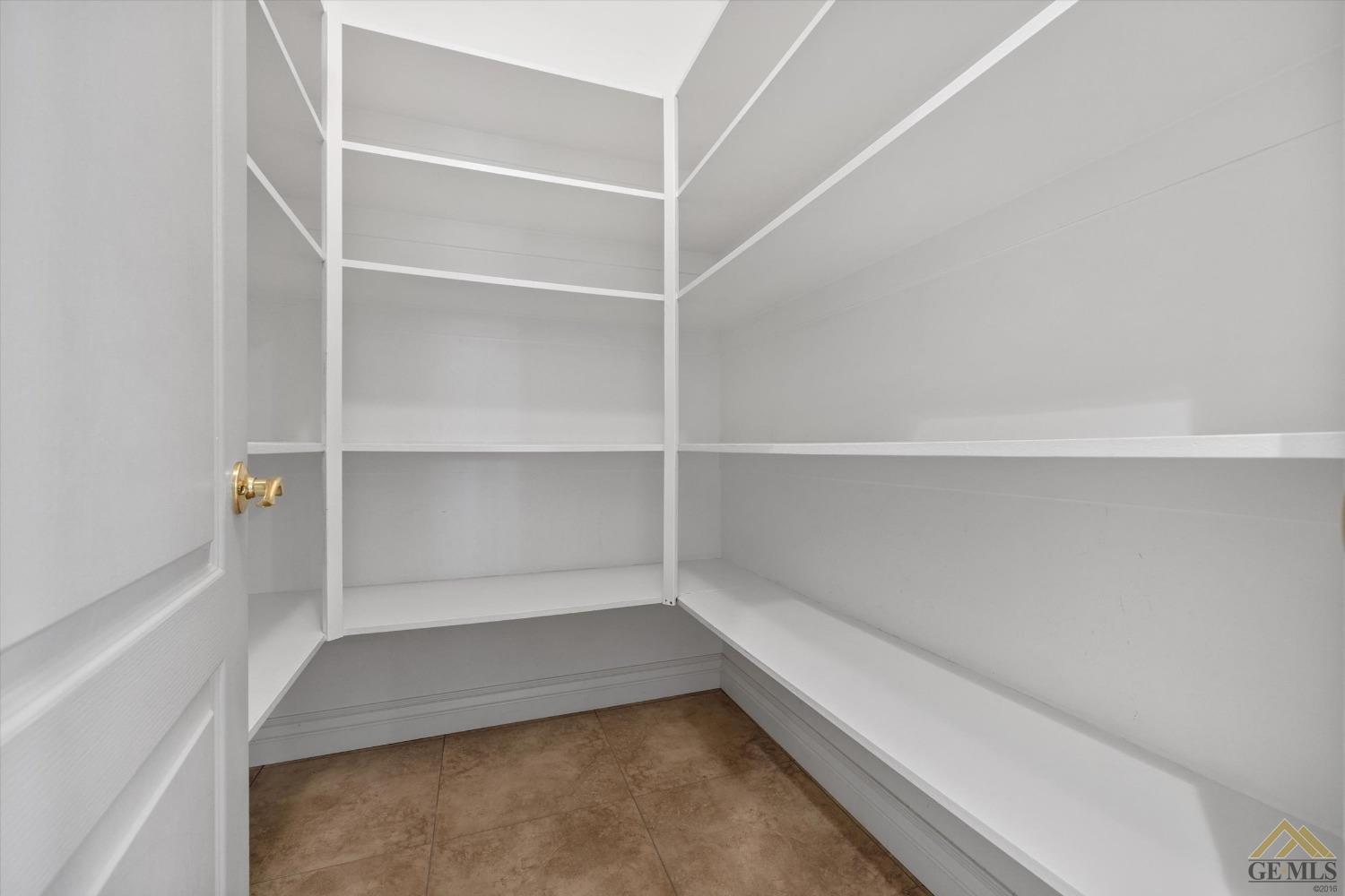 Undisclosed Address Bakersfield, CA 93311 - Photo 45 of 57 a view of an empty walk in closet