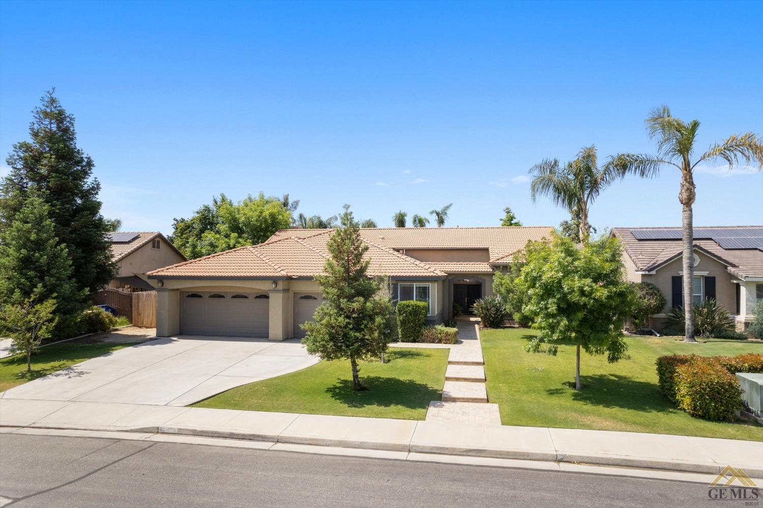 Undisclosed Address Bakersfield, CA 93311 - Photo 9 of 57 a front view of a house with a garden