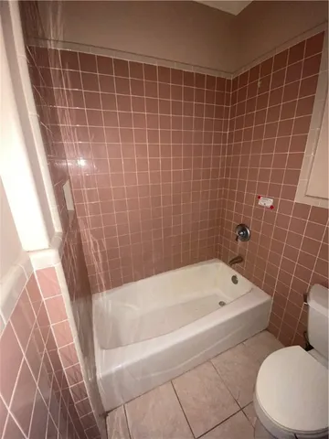 a bathroom with a bathtub and a toilet