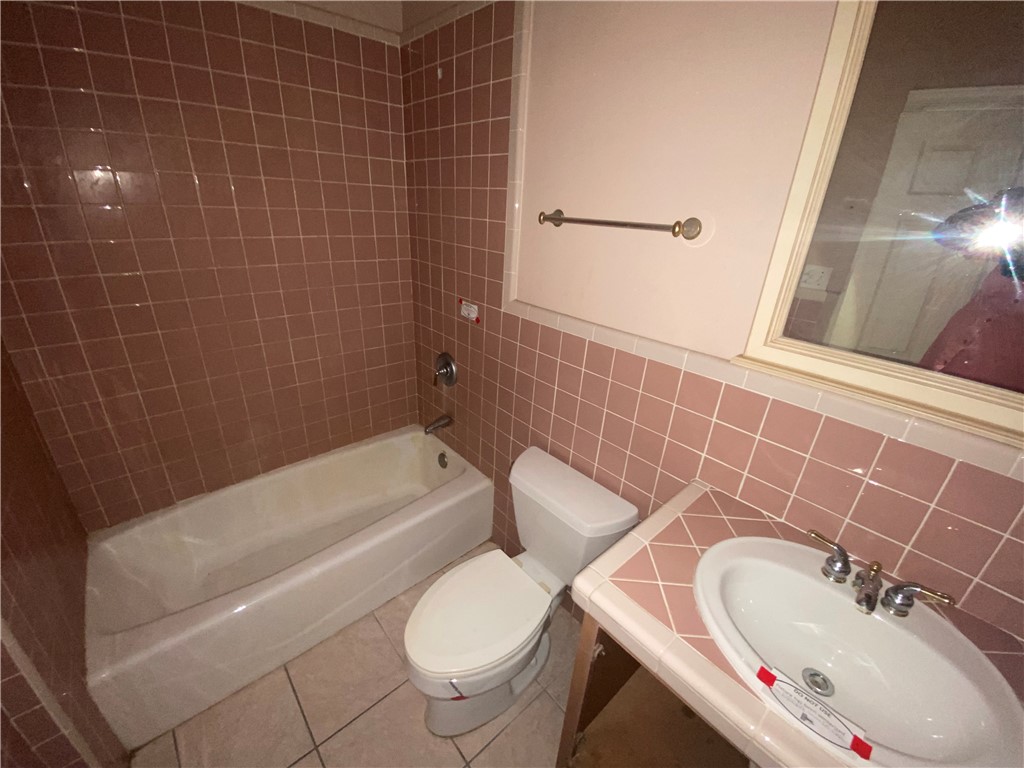 527 County Road 137 Alice, TX 78332 - Photo 16 of 32 a bathroom with a sink toilet and shower