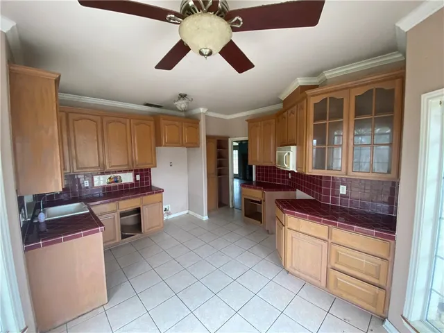 a kitchen with stainless steel appliances granite countertop a stove and a refrigerator