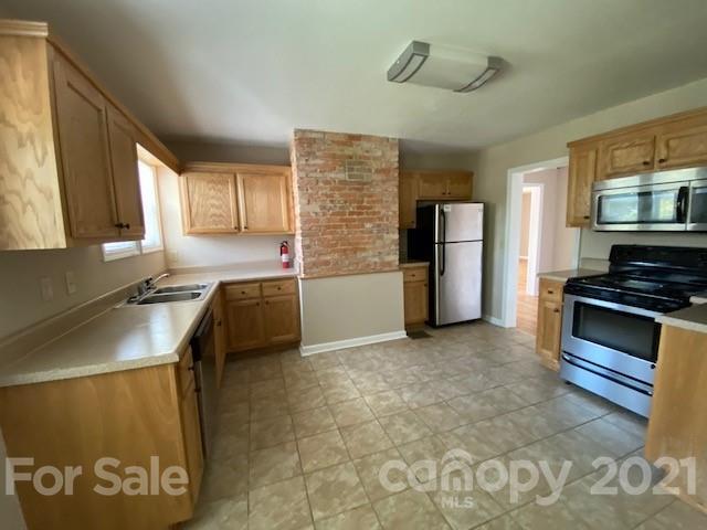 369 North Canton Road Canton, NC 28716 - Photo 16 of 21 a kitchen with a refrigerator and a sink