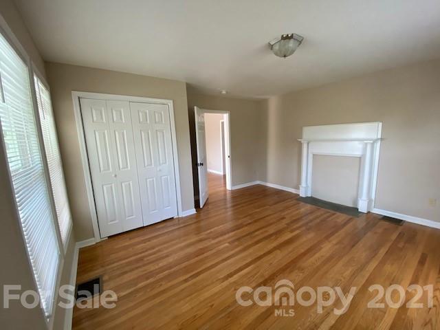369 North Canton Road Canton, NC 28716 - Photo 8 of 21 a view of empty room with wooden floor and fan