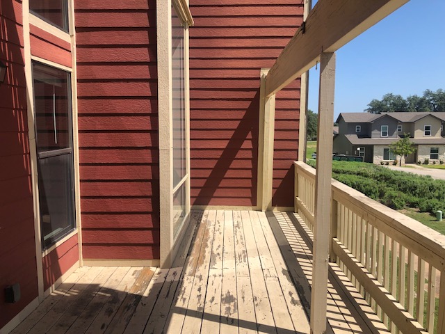 505 Demarett Drive, Unit 12 Point Venture, TX 78645 - Photo 12 of 15 a view of balcony with wooden floor and fence