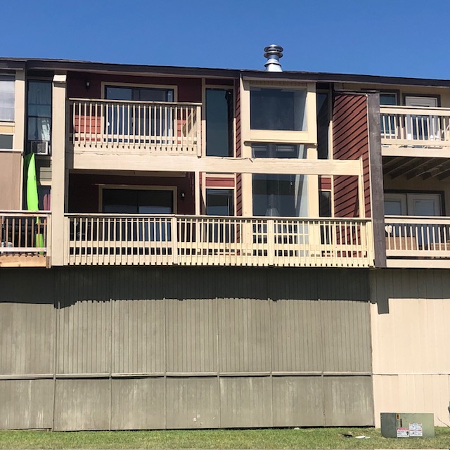 505 Demarett Drive, Unit 12 Point Venture, TX 78645 - Photo 2 of 15 a front view of a house with a balcony