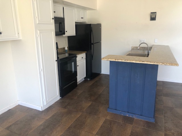 505 Demarett Drive, Unit 12 Point Venture, TX 78645 - Photo 7 of 15 a kitchen with stainless steel appliances a refrigerator and a sink