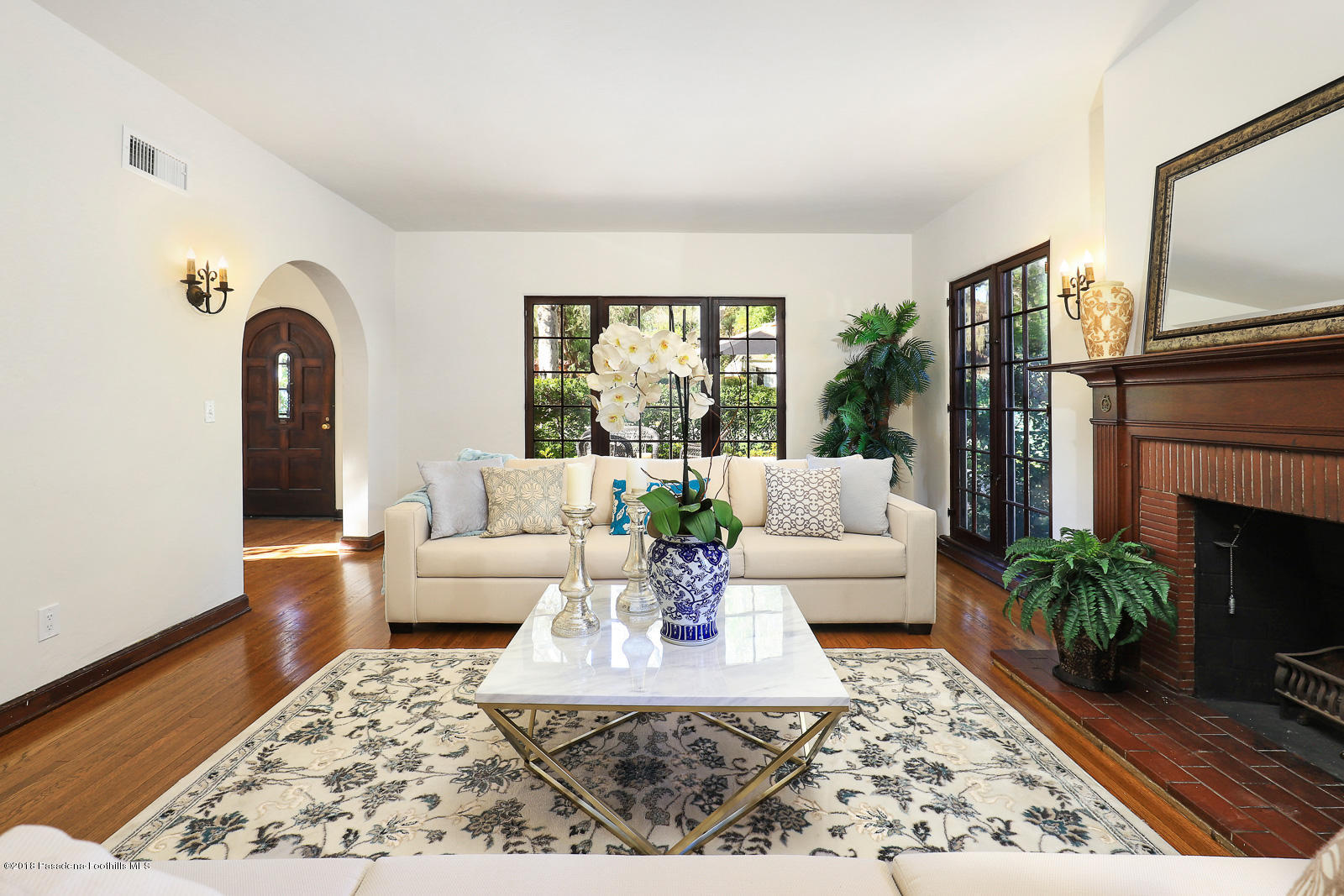 884 Old Mill Road Pasadena, CA 91108 - Photo 14 of 32 a living room with furniture a fireplace and a potted plant