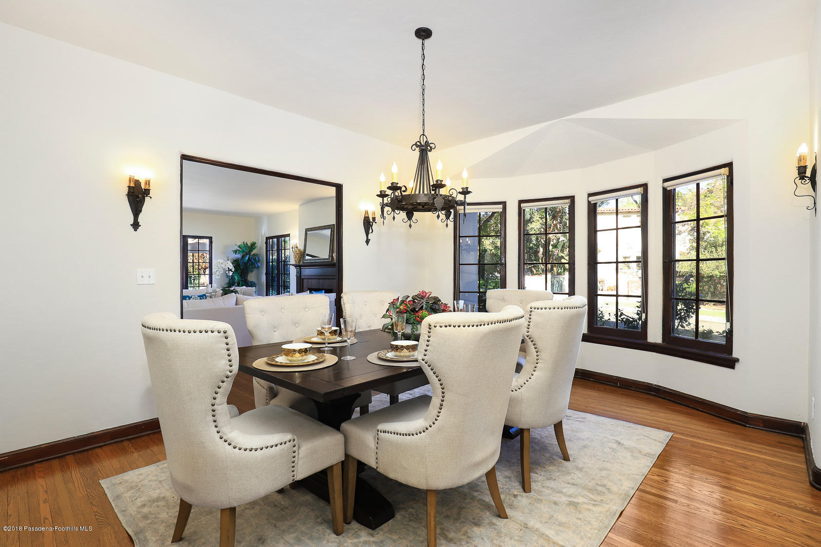 884 Old Mill Road Pasadena, CA 91108 - Photo 16 of 32 a dining room with furniture a chandelier and wooden floor