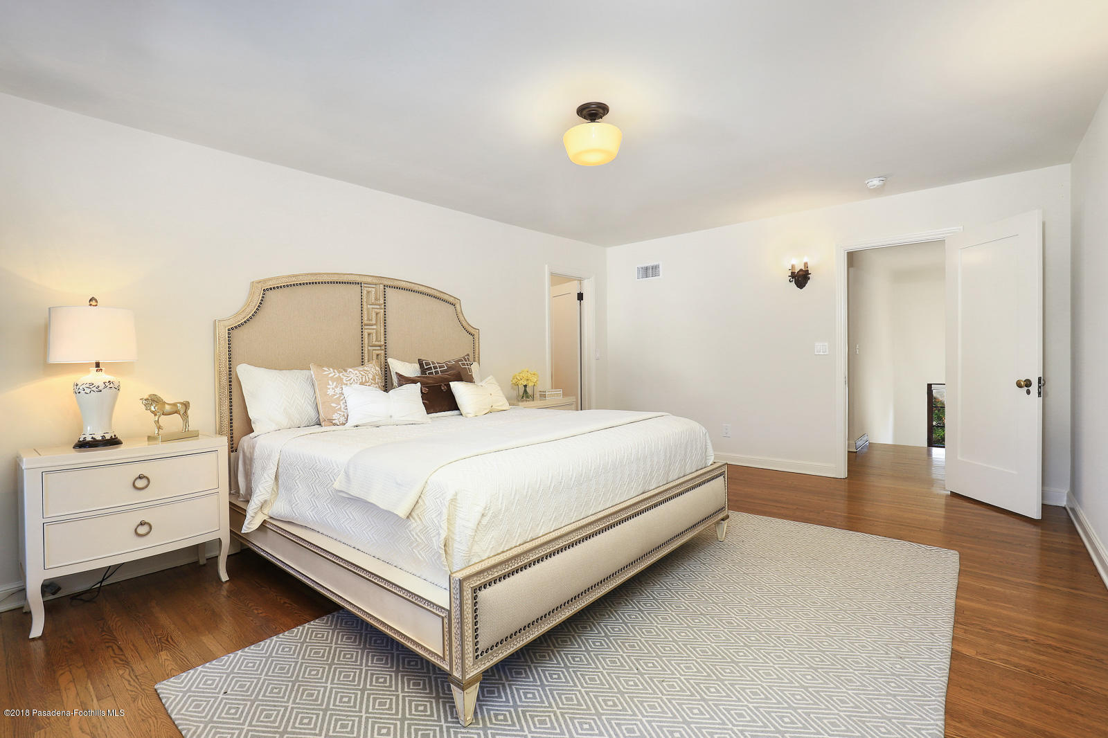 884 Old Mill Road Pasadena, CA 91108 - Photo 25 of 32 a bedroom with a bed and wooden floor