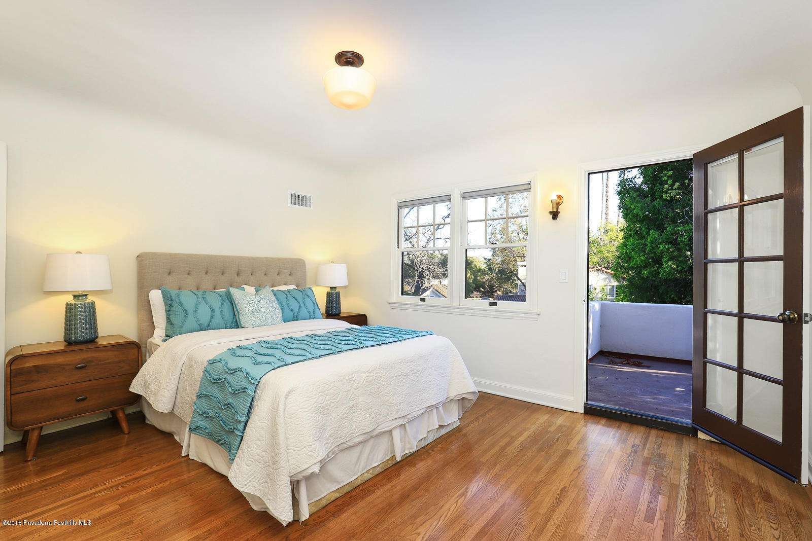 884 Old Mill Road Pasadena, CA 91108 - Photo 28 of 32 a bedroom with a bed and a large window