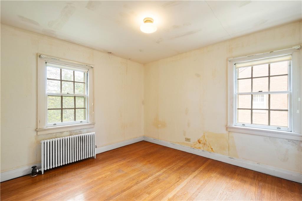 426 Sulgrave Road Pittsburgh, PA 15211 - Photo 34 of 39 an empty room with wooden floor and windows