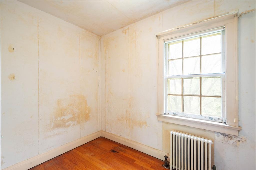 426 Sulgrave Road Pittsburgh, PA 15211 - Photo 35 of 39 an empty room with wooden floor and windows