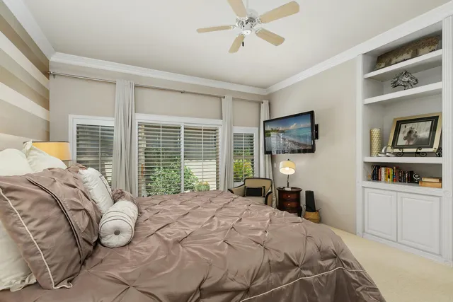 a bedroom with a bed and a flat tv screen on the dresser
