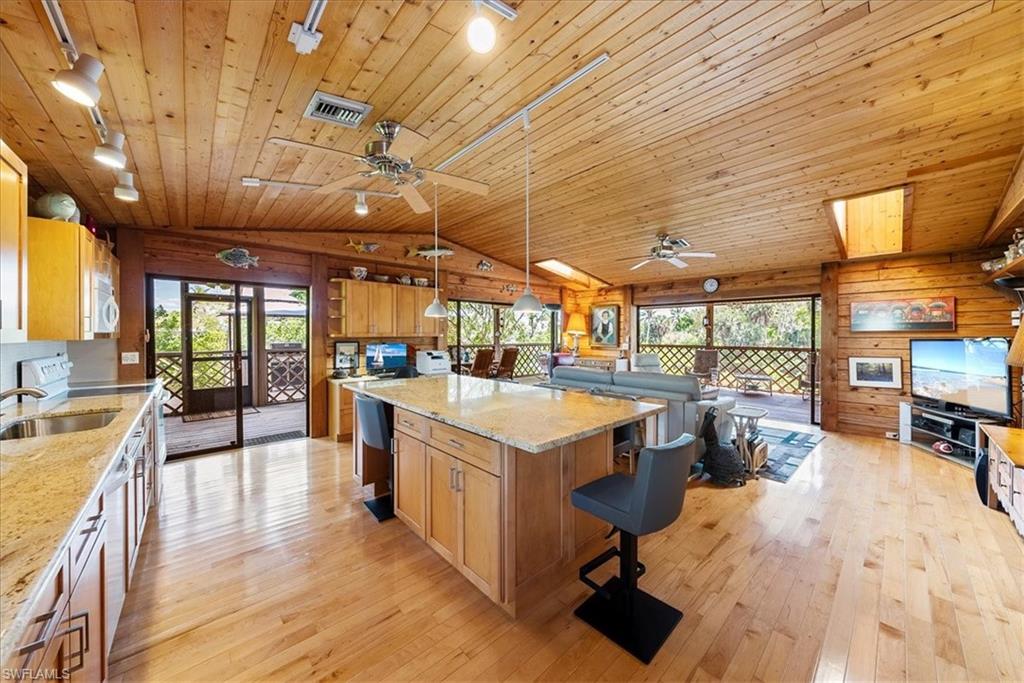 2997 Poplar Street Naples, FL 34112 - Photo 15 of 49 a view of a kitchen with furniture and a wooden floor