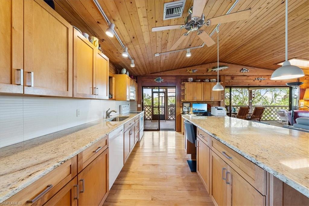 2997 Poplar Street Naples, FL 34112 - Photo 17 of 49 a large kitchen with stainless steel appliances granite countertop a lot of counter space