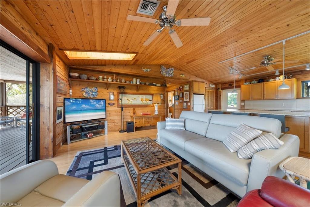 2997 Poplar Street Naples, FL 34112 - Photo 21 of 49 a living room with furniture and a flat screen tv