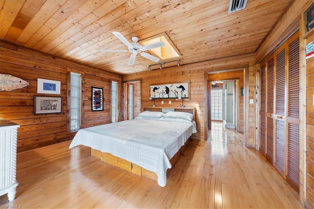 2997 Poplar Street Naples, FL 34112 - Photo 26 of 49 a bed room with a bed and a television