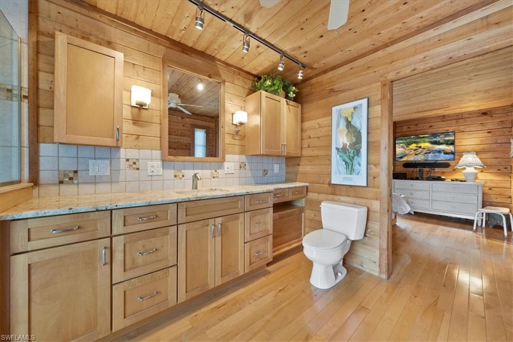 2997 Poplar Street Naples, FL 34112 - Photo 29 of 49 a bathroom with a sink and a toilet