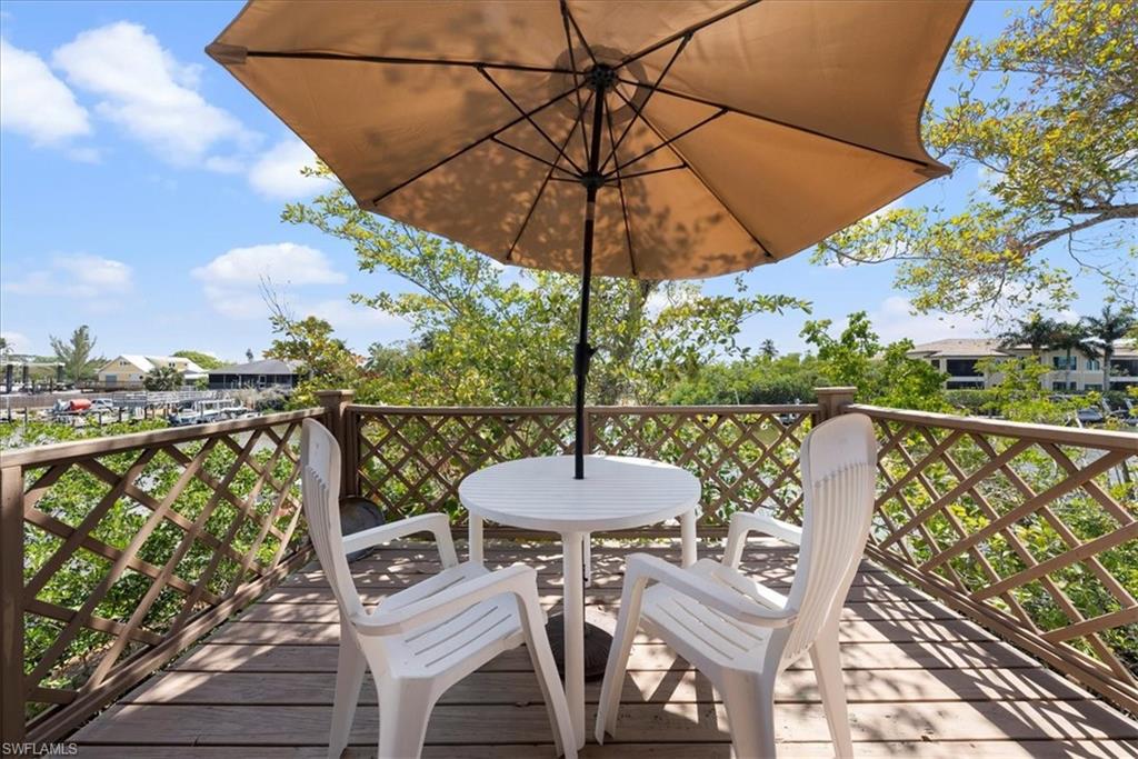2997 Poplar Street Naples, FL 34112 - Photo 35 of 49 a view of a balcony with furniture and wooden floor