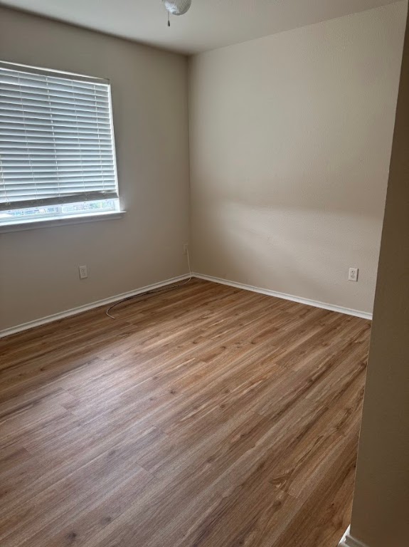 15130 Meredith Lane College Station, TX 77845 - Photo 12 of 16 a view of an empty room with wooden floor and a window