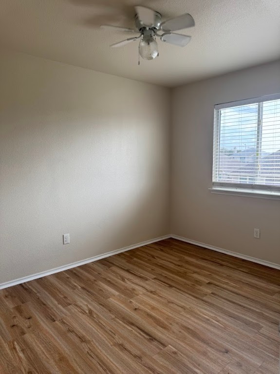 15130 Meredith Lane College Station, TX 77845 - Photo 14 of 16 an empty room with wooden floor fan and windows