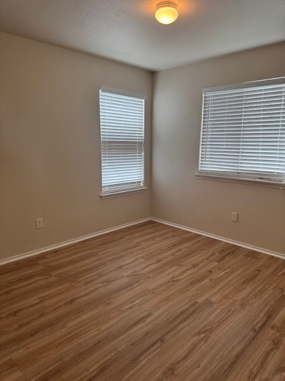 15130 Meredith Lane College Station, TX 77845 - Photo 15 of 16 an empty room with wooden floor and windows