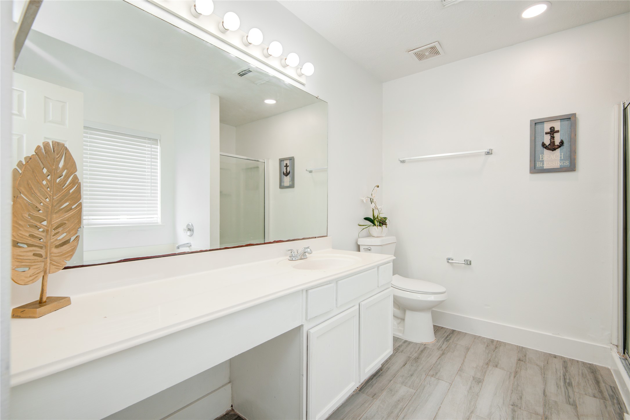 10023 Farrell Drive Houston, TX 77070 - Photo 15 of 26 a bathroom with a sink a toilet and mirror