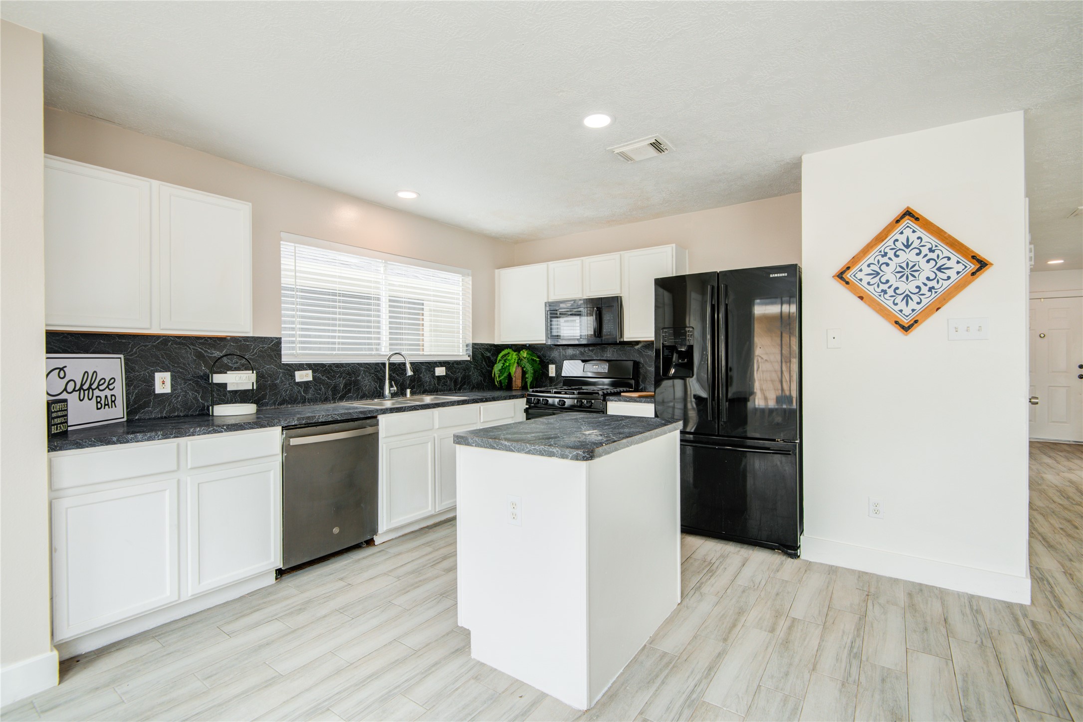 10023 Farrell Drive Houston, TX 77070 - Photo 10 of 26 a kitchen with granite countertop a refrigerator stove top oven and sink