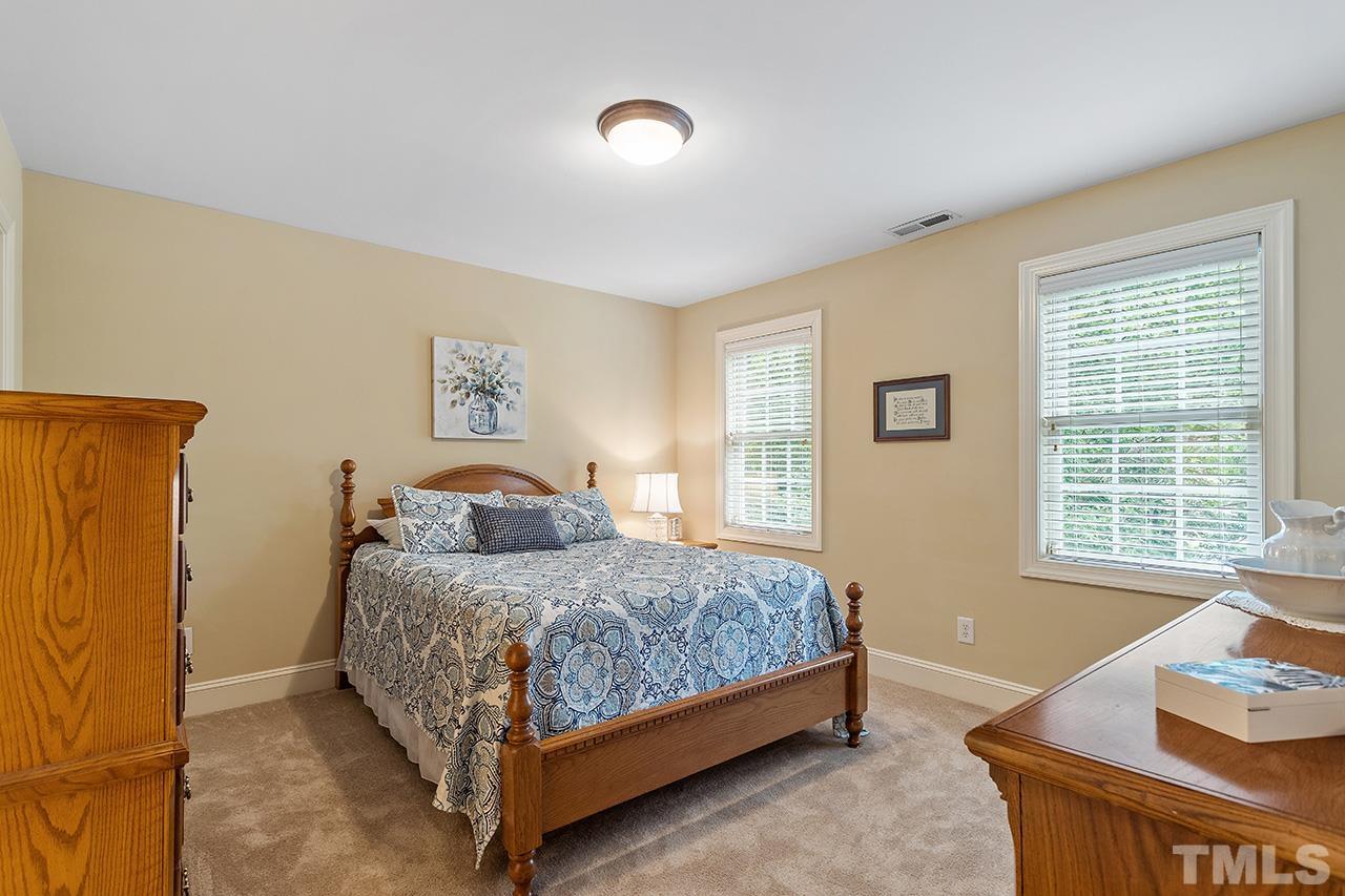 3102 Ringland Road Raleigh, NC 27613 - Photo 24 of 42 a bedroom with a bed and window