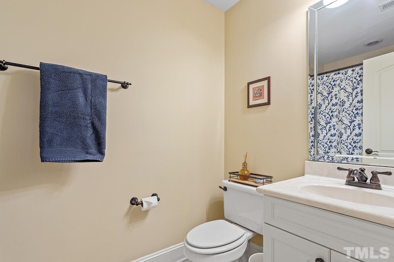 3102 Ringland Road Raleigh, NC 27613 - Photo 25 of 42 a bathroom with a sink a toilet and shower