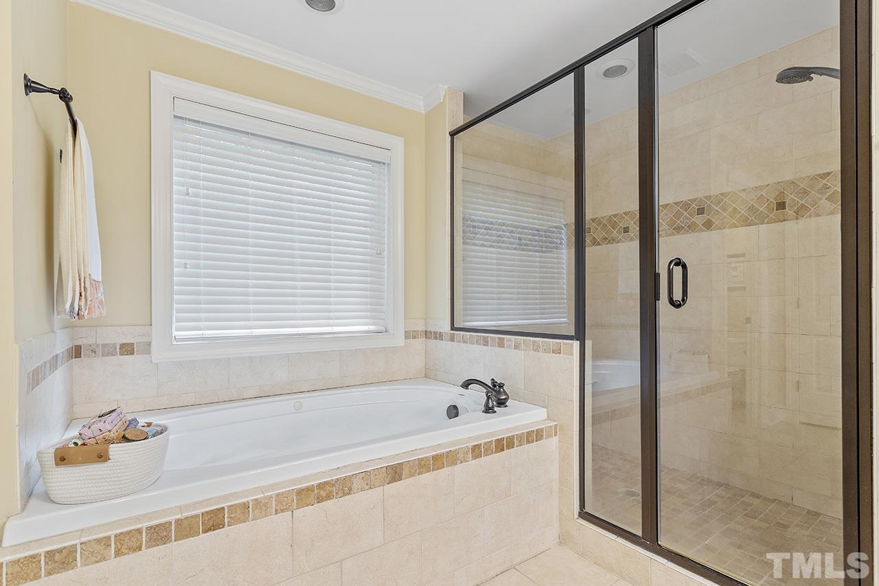 3102 Ringland Road Raleigh, NC 27613 - Photo 34 of 42 a bathroom with a bathtub and a shower