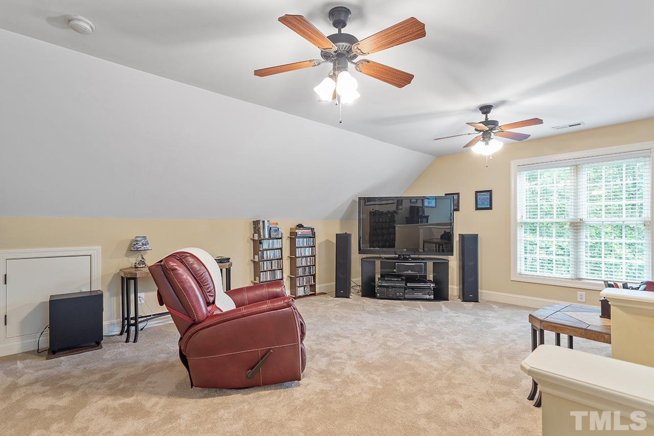 3102 Ringland Road Raleigh, NC 27613 - Photo 36 of 42 a living room with furniture and a flat screen tv