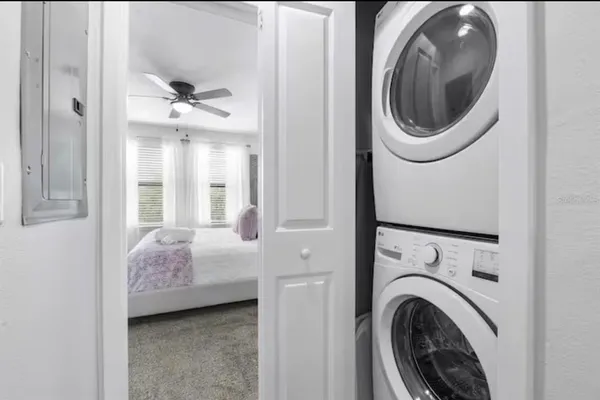 a bedroom with a bed and glass window