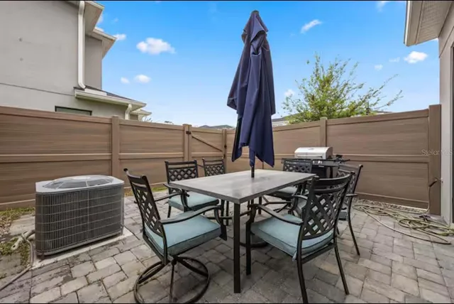 a view of a chairs and table in patio