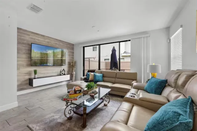 a living room with furniture and a large window
