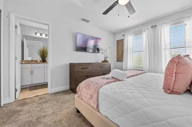 a bedroom with a bed and a flat screen tv