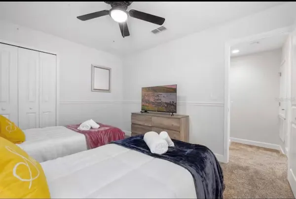 a bedroom with a bed and a tv