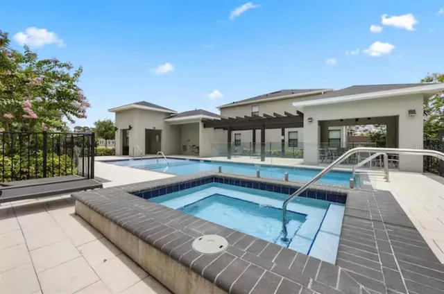 a view of a house with swimming pool and sitting area