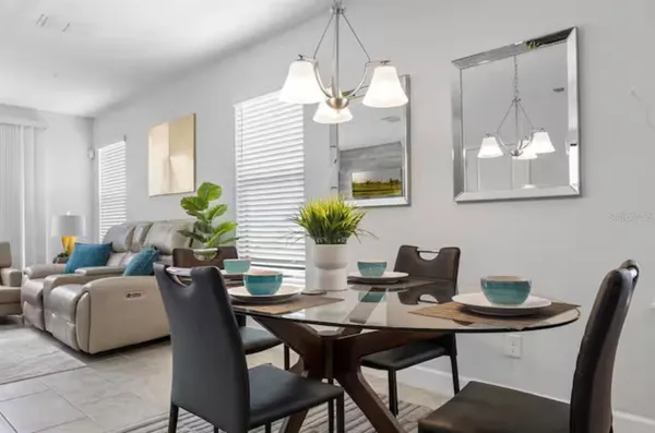 a view of a dining room with furniture and chandelier