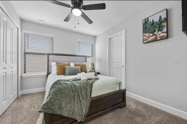 a bedroom with a bed and a chandelier