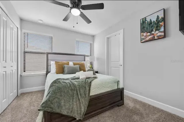 a bedroom with a bed and a chandelier