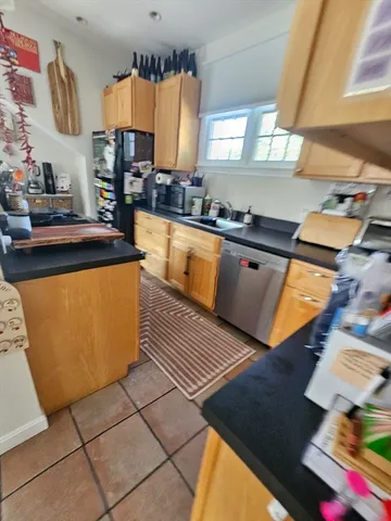 a kitchen with stainless steel appliances granite countertop a sink counter space and a window
