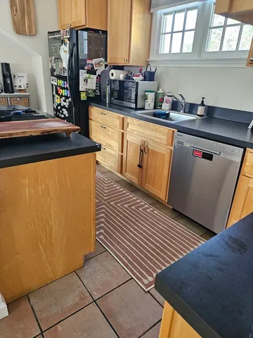 a kitchen with stainless steel appliances a sink and a stove