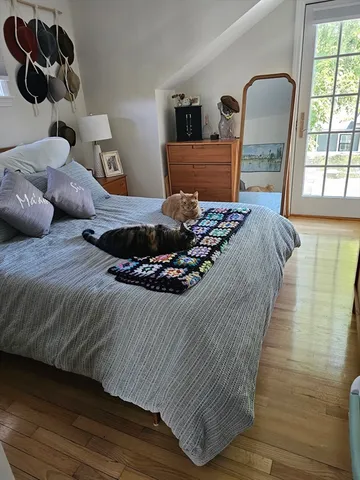 a bed sitting in a bedroom next to a window