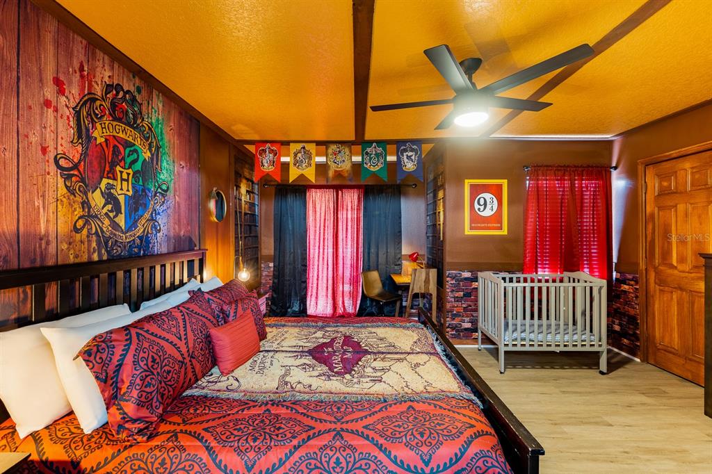 891 Assembly Court Reunion, FL 34747 - Photo 14 of 54 a bed room with a bed and a painting on the wall