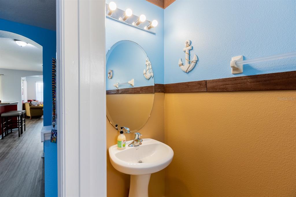 891 Assembly Court Reunion, FL 34747 - Photo 22 of 54 a bathroom with a sink and a mirror