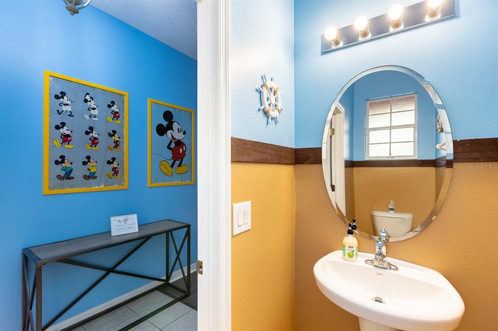 891 Assembly Court Reunion, FL 34747 - Photo 23 of 54 a bathroom with a sink a mirror and a shower