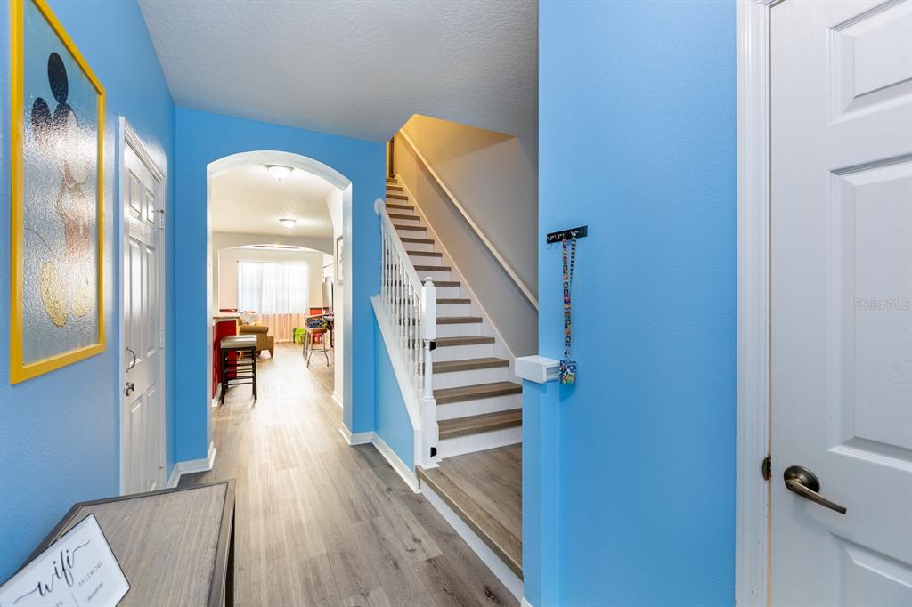 891 Assembly Court Reunion, FL 34747 - Photo 28 of 54 a view of a hallway with wooden floor and staircase